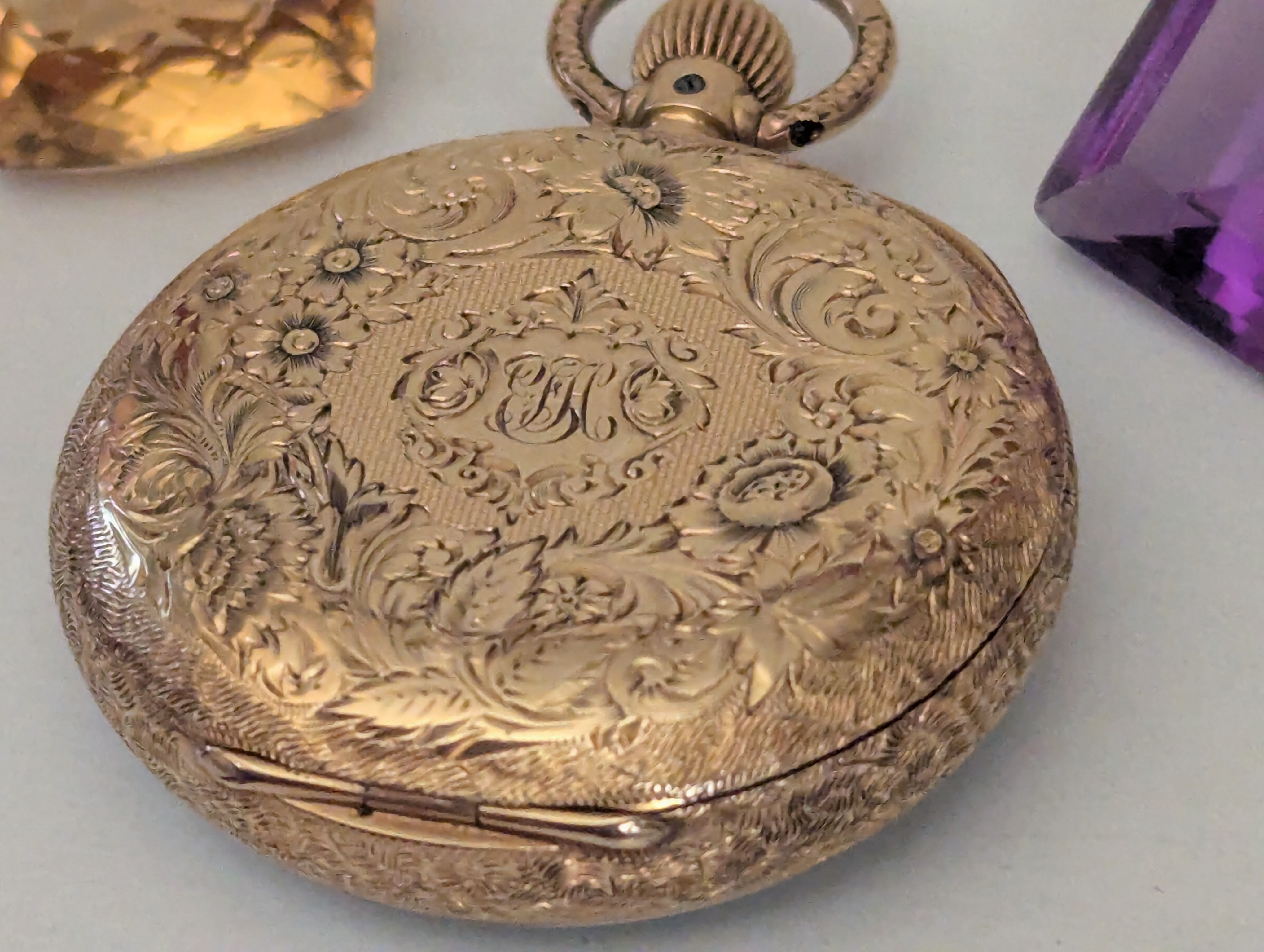 Overall zoomed out view of watch with two gemstones